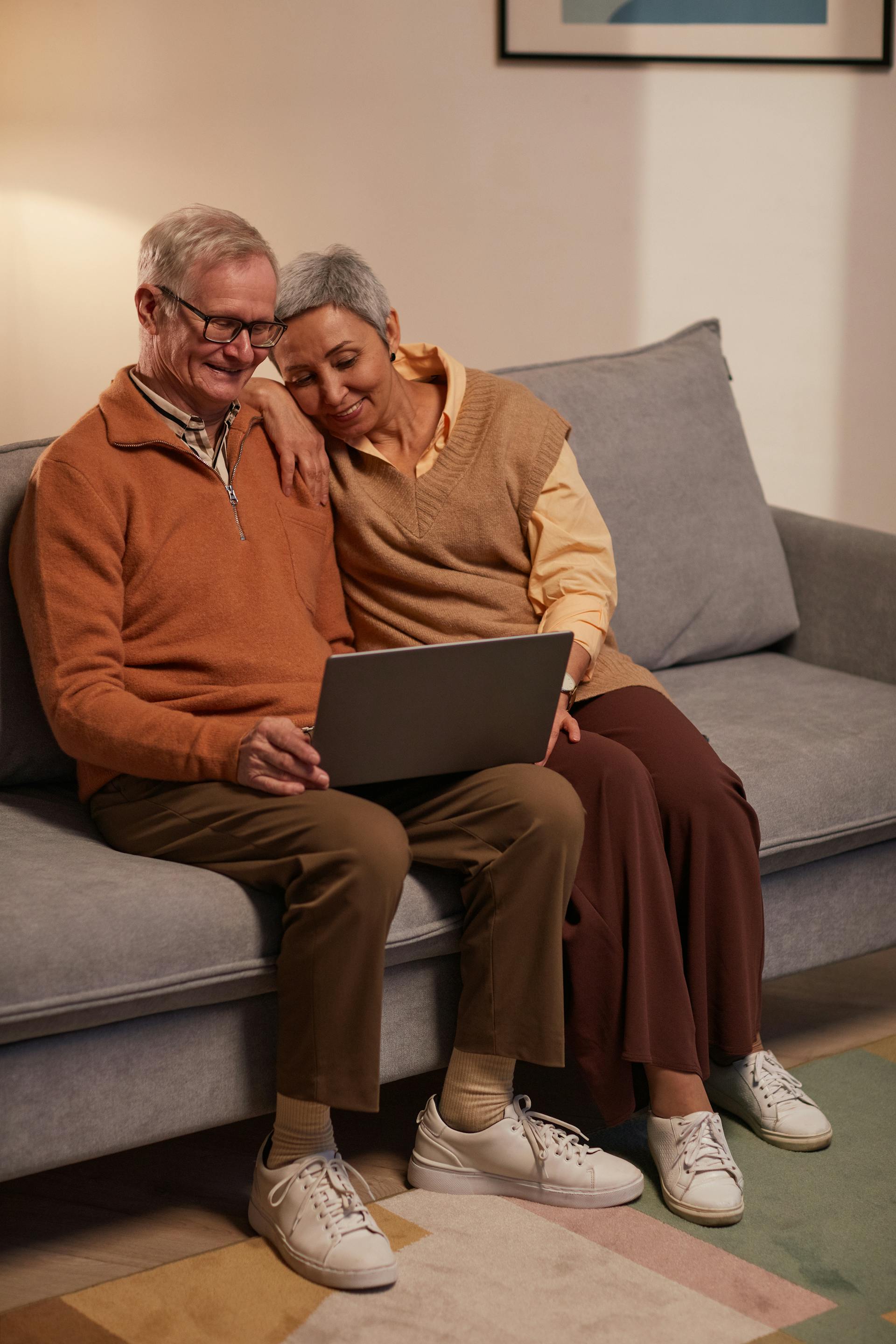 Senior couple on the sofa enjoying a relaxing video Wellness Circle session