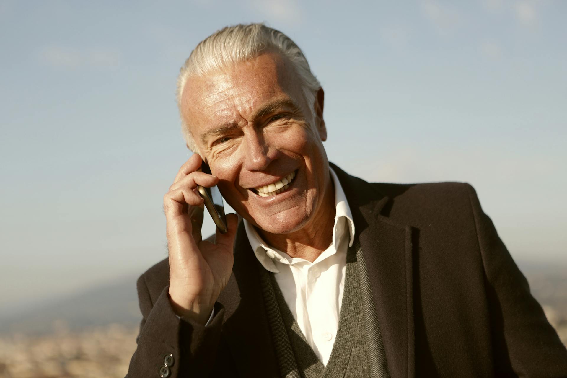 Senior man with gray-white hair smiling warmly, connected with his Social Circle community
