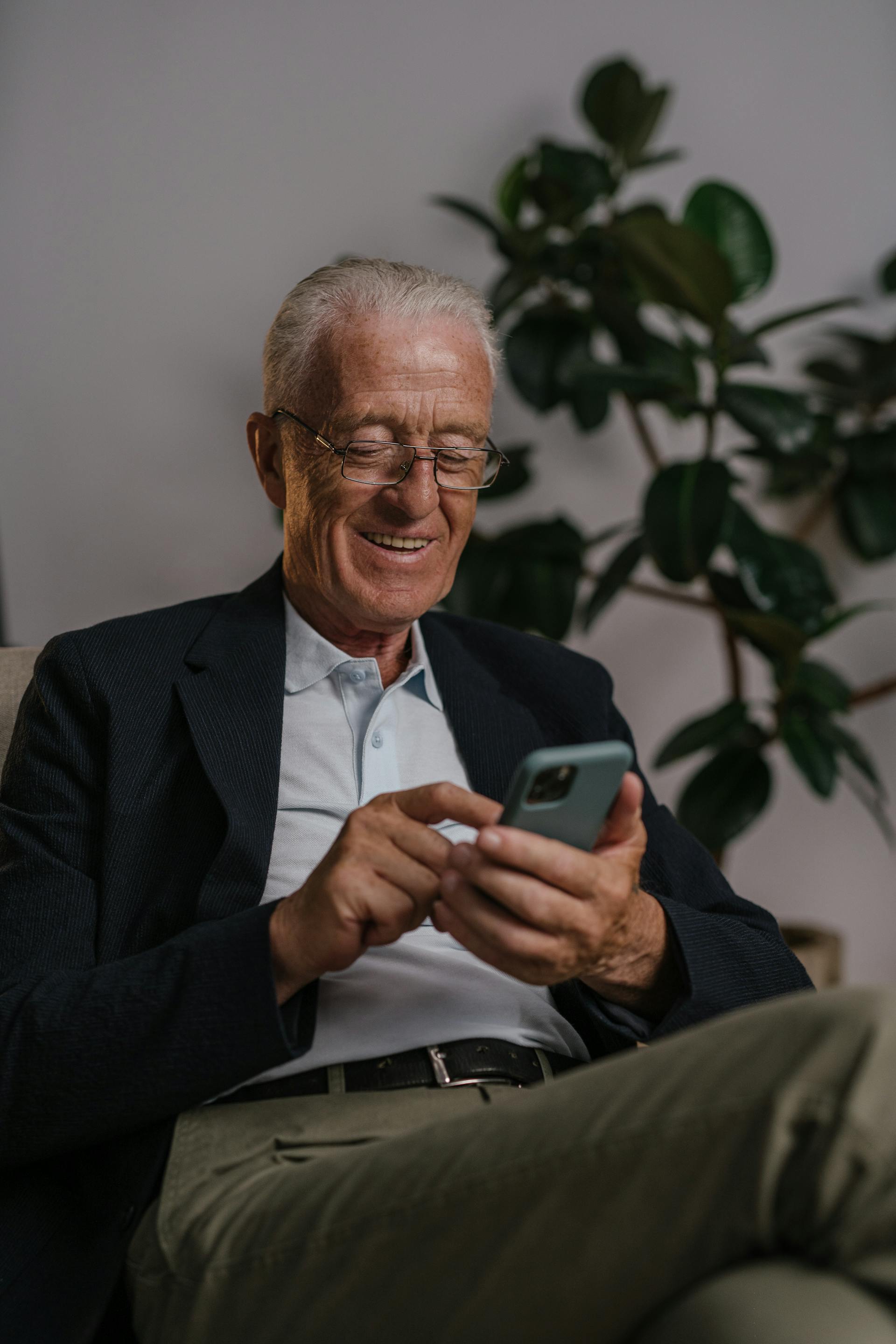 Older woman with gray hair laughing during a video call — the joy of our Social Circle sessions